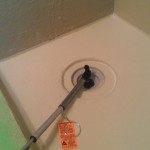 A prepared tile shower with waterproofing during the flood testing phase of the project.