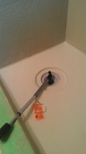 A prepared tile shower with waterproofing during the flood testing phase of the project.