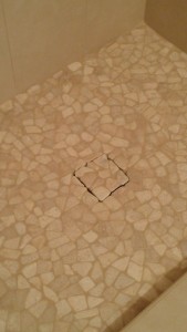 pebble shower floor with a tile drain insert